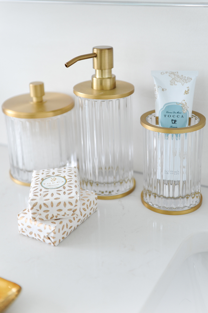 three brass topped jars in bathroom