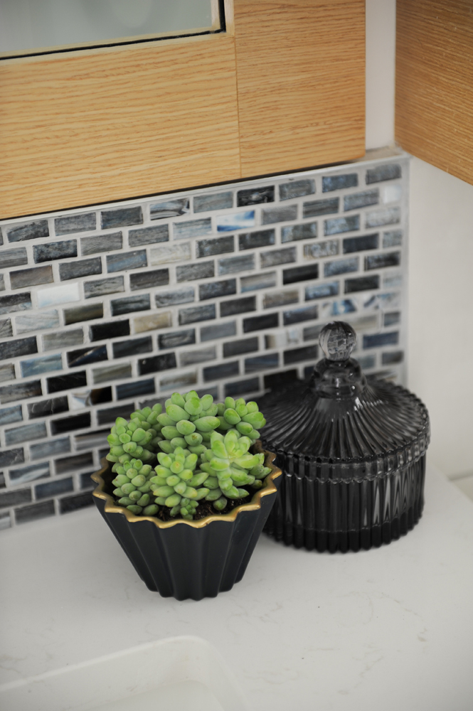 Modern bathroom with glossy mini-brick tile backsplash.