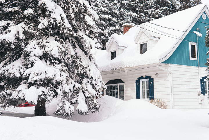 quaint country house covered in snow
