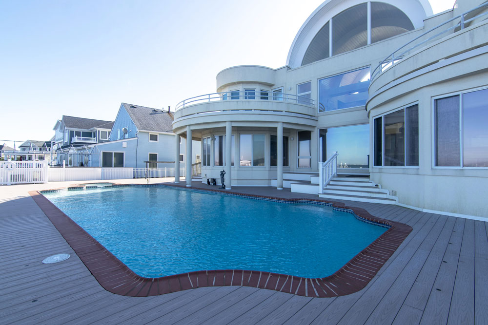 An outdoor pool that can be reached by the downstairs party room