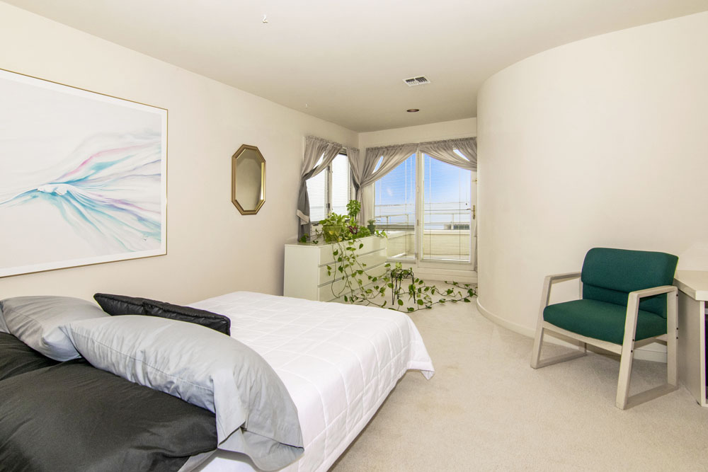 A smaller guest bedroom with a private terrace overlooking the Jersey Shore waterfront