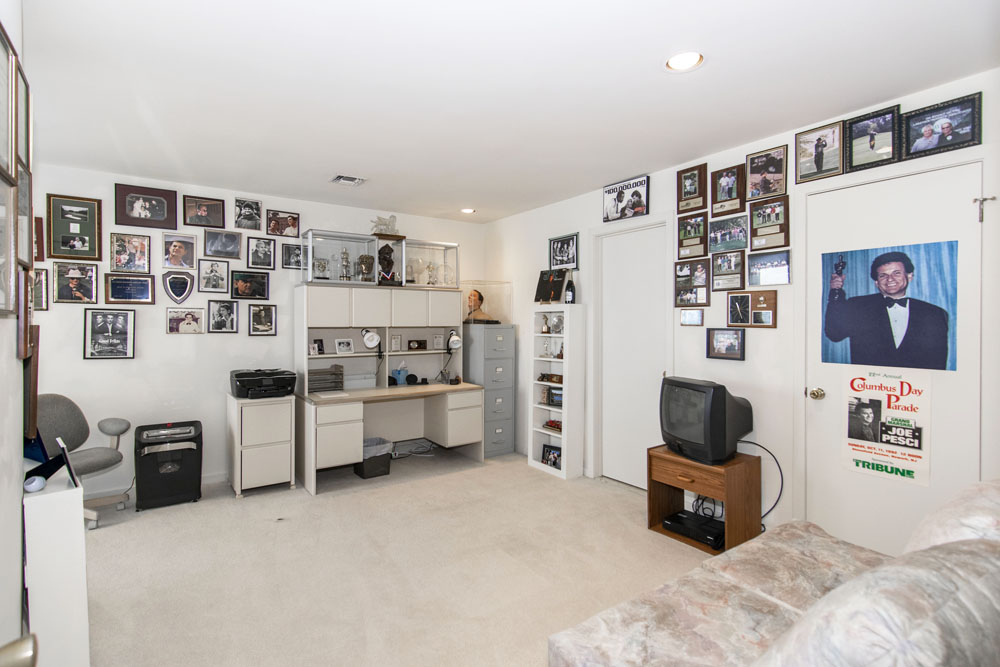 Private office with plenty of personal photos on the walls and awards in a glass case