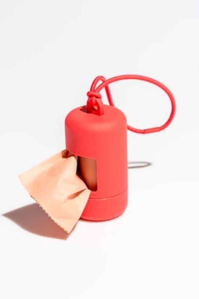 An orange-red poop bag carrier for dogs