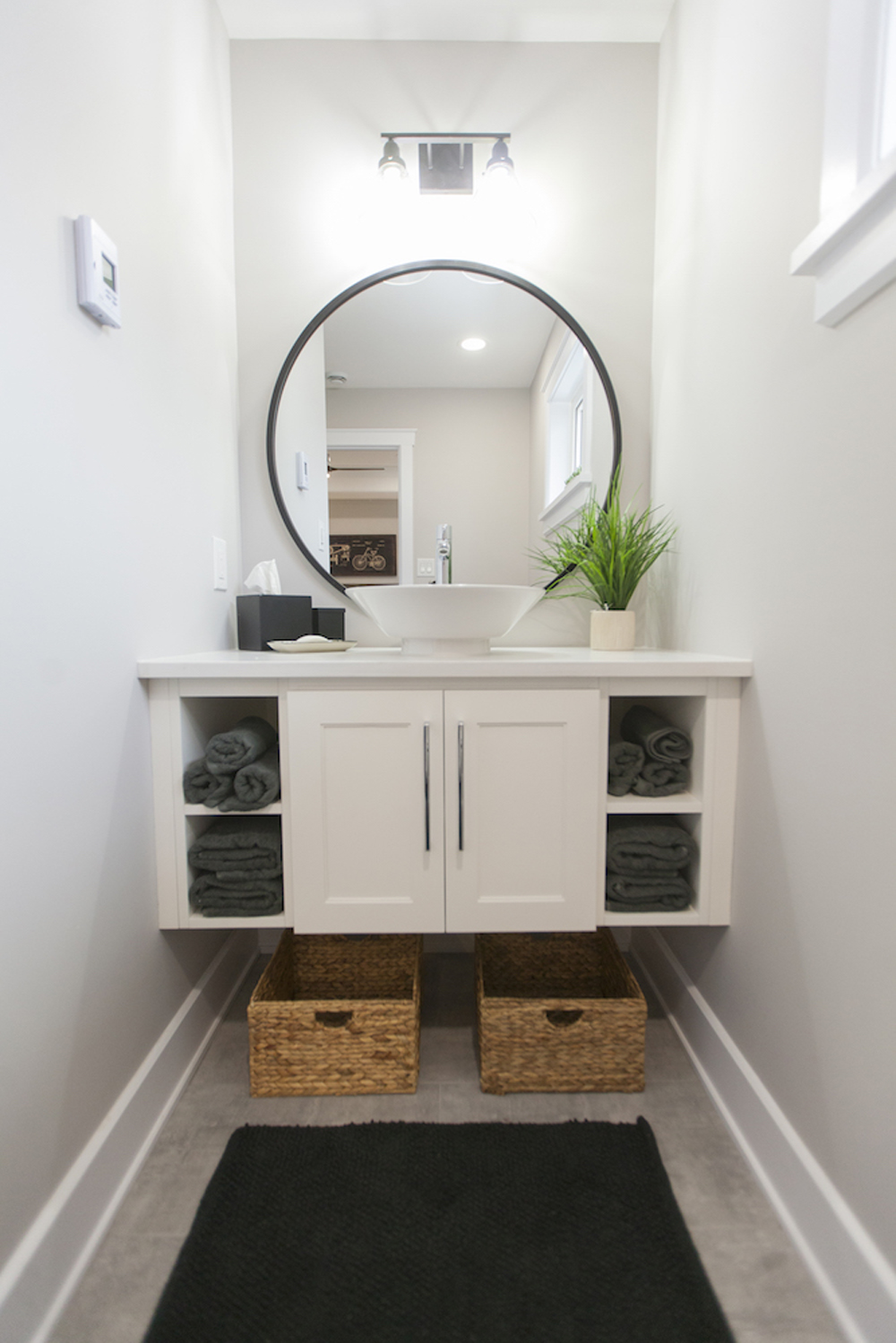 A custom-made white floating vanity in a tiny ensuite bathroom
