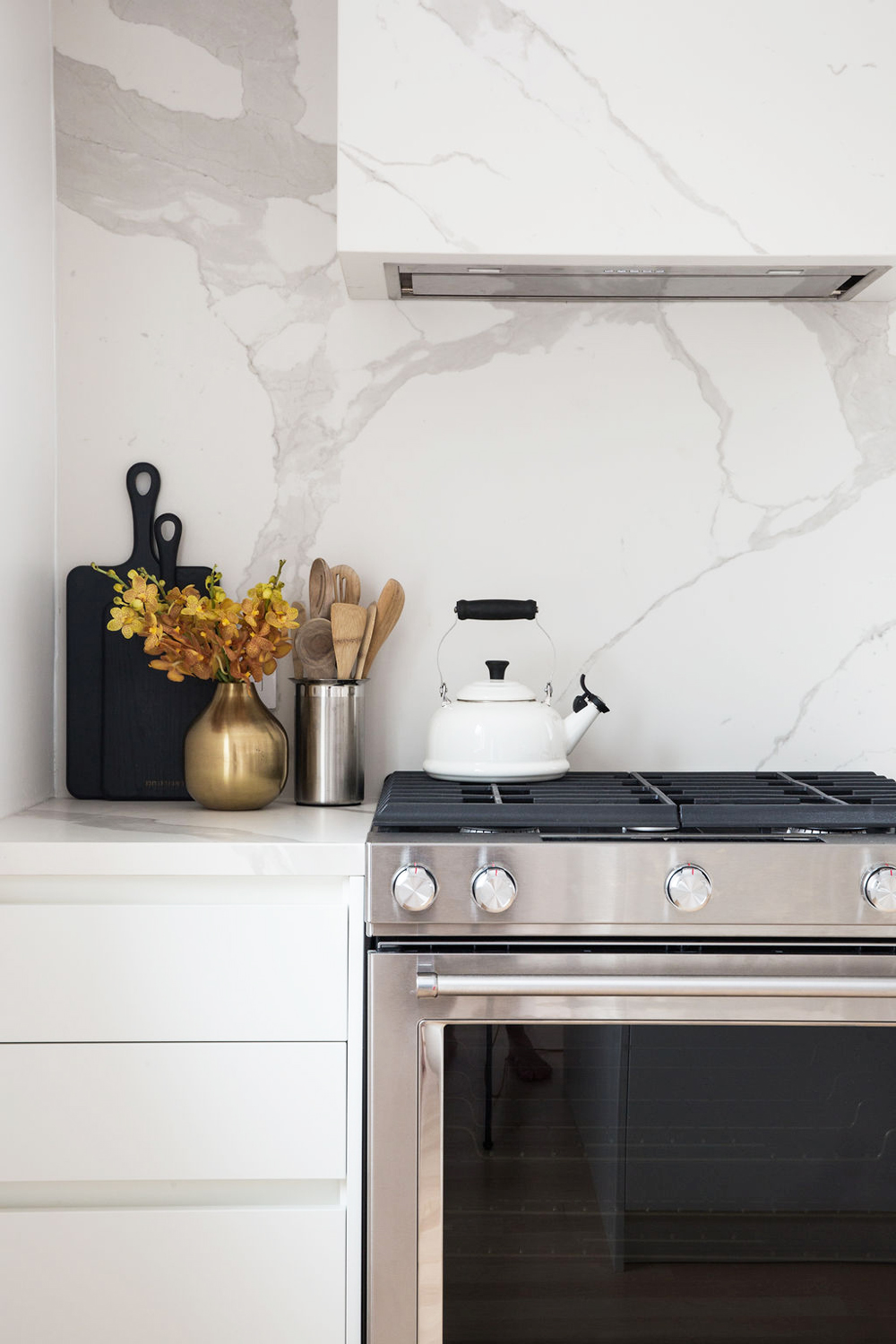 A clutter-free kitchen featuring metallic hardware and a minimalist approach