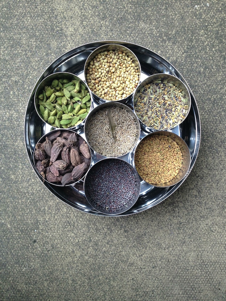 silver masala dabba filled with spices