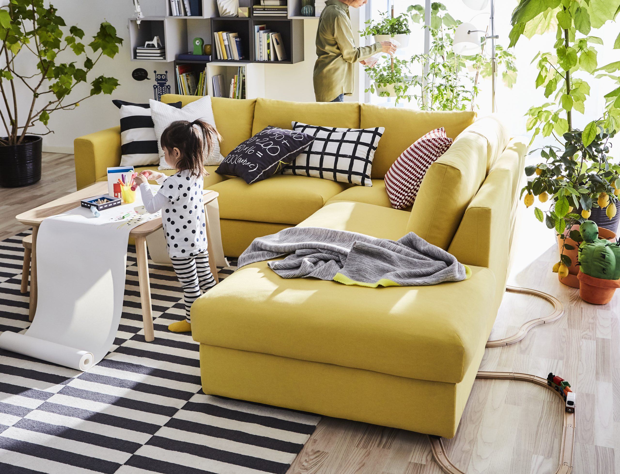 Yellow sofa in living room with table for arts and crafts for kids