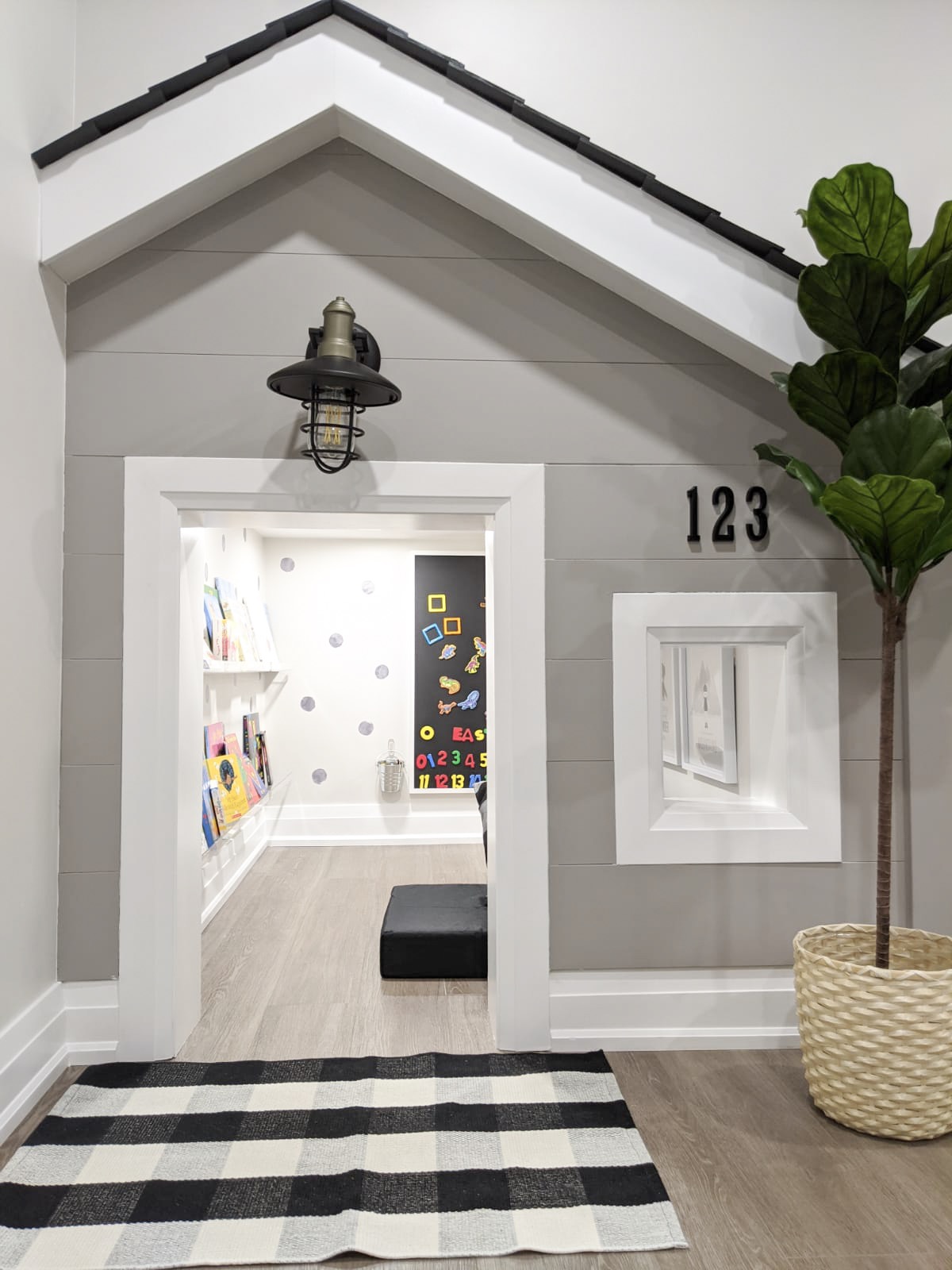 Sweet playroom made to resemble a house off living room basement
