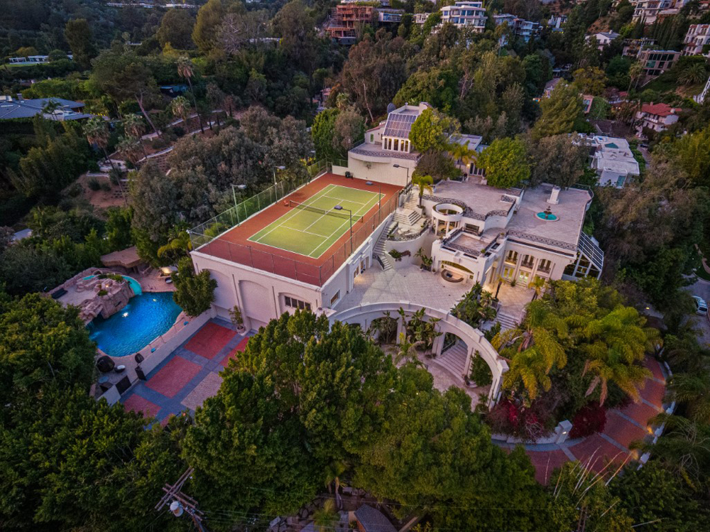 An aerial exterior shot of Prince's former Los Angeles mansion with swimming pool and rooftop tennis court