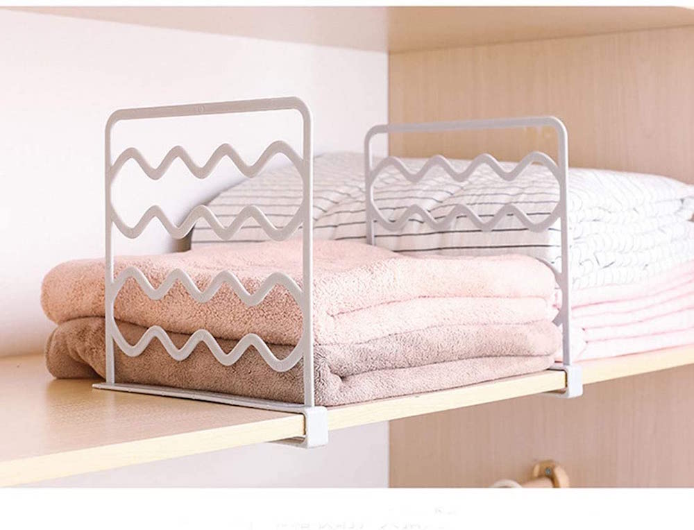 wooden shelf with towels and white dividers