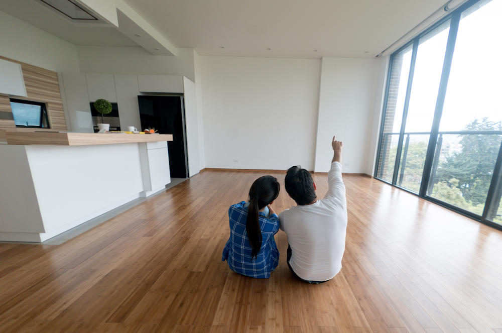 couple on floor planning decorating in modern white apartment