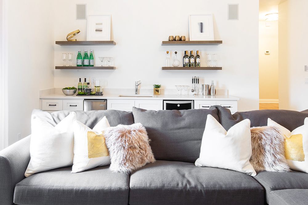 A renovated living room with a not-so-mini bar that nearly runs the length of the couch