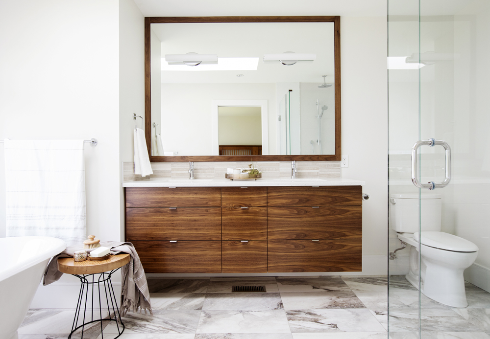 Bright white master bathroom with stylish wood elements.