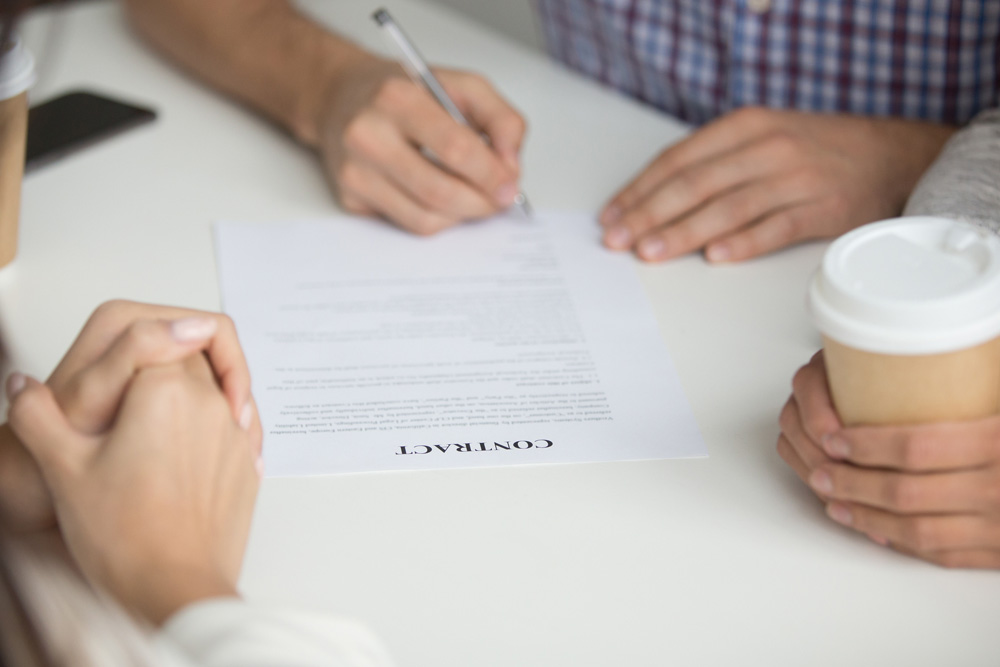 Husband signing contract of buying house
