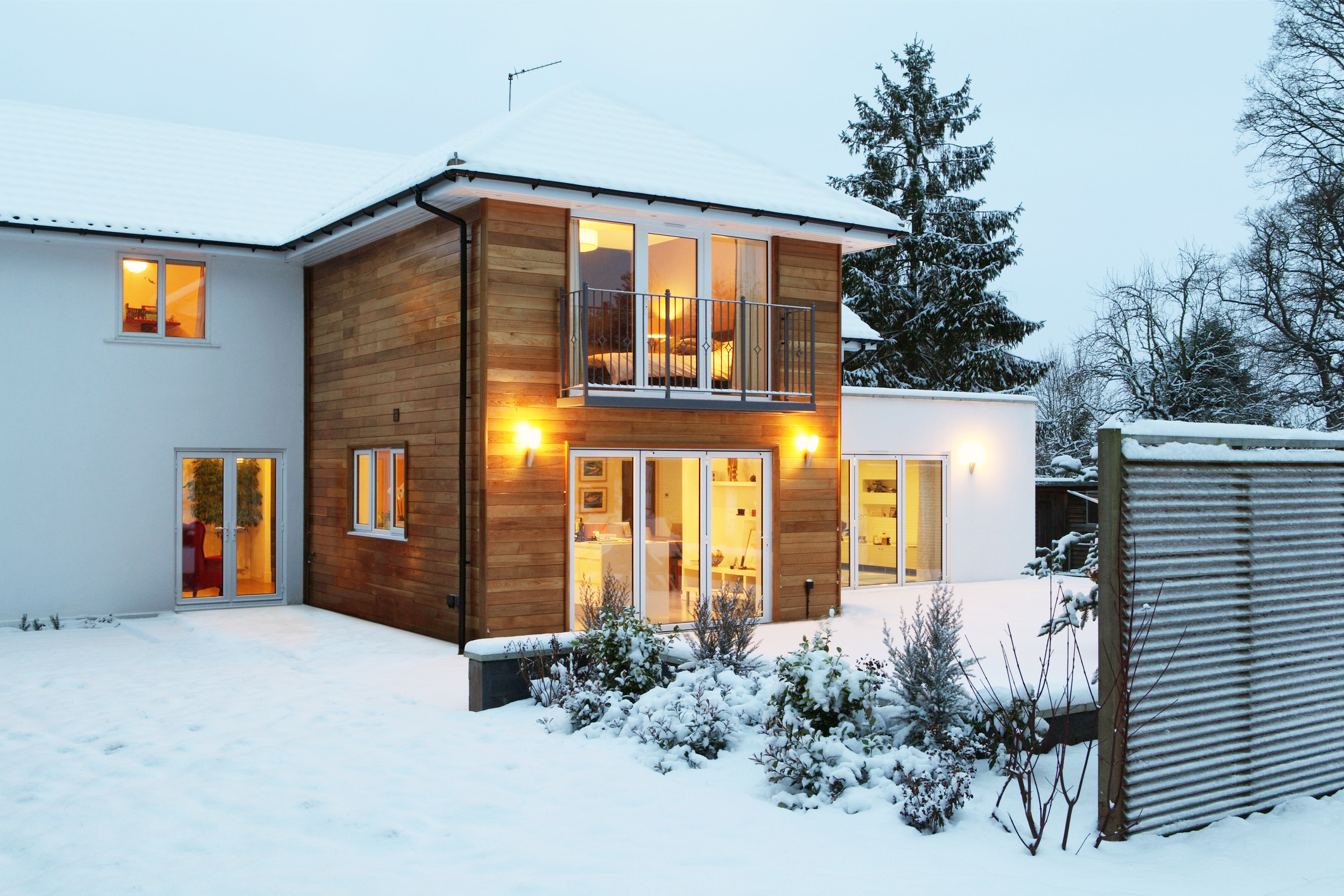 Illuminated family home in snow