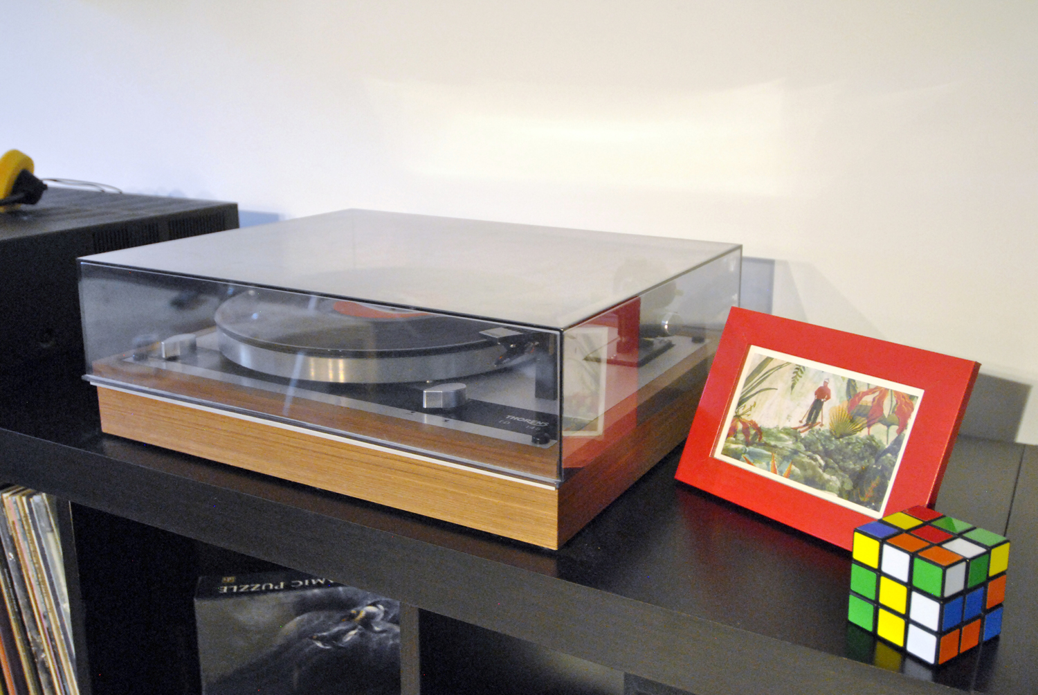 A vintage record player in a basement apartment