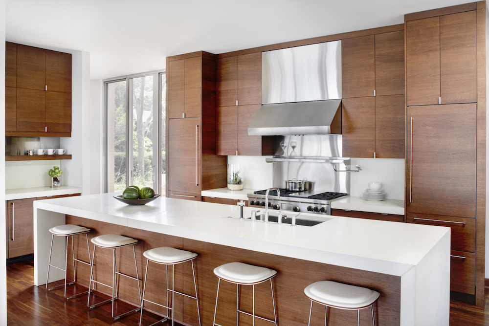 Modern white and wood kitchen with breakfast bar and stainless appliances