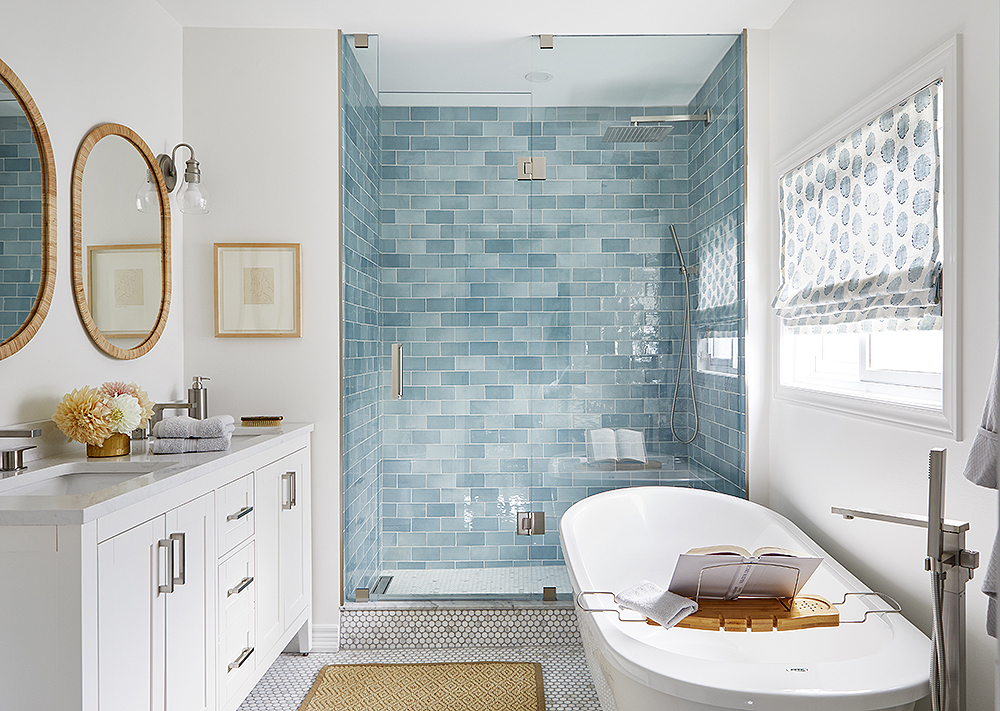 blue-and-white bathroom with tiled shower and double vanity