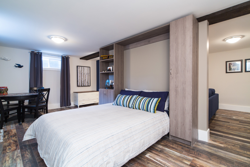 Murphy bed with white and blue linens