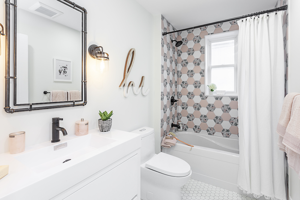 white bathroom with pink hex-tile shower