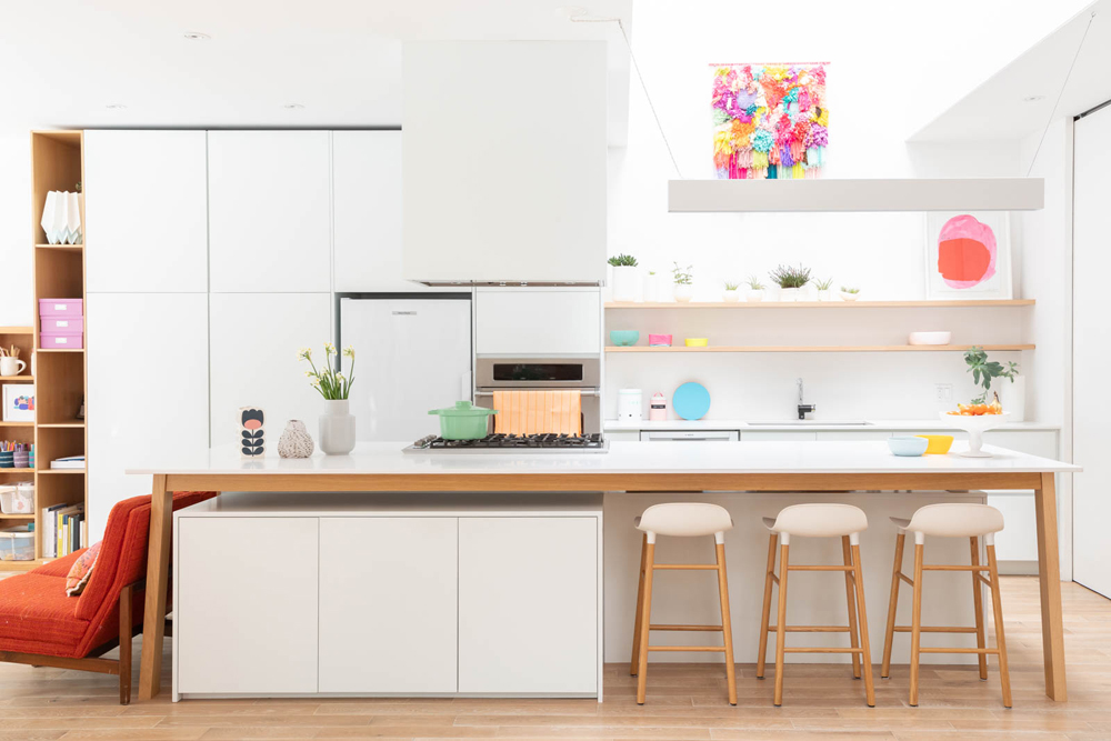 A bright, colourful open-concept kitchen with vibrant dishware