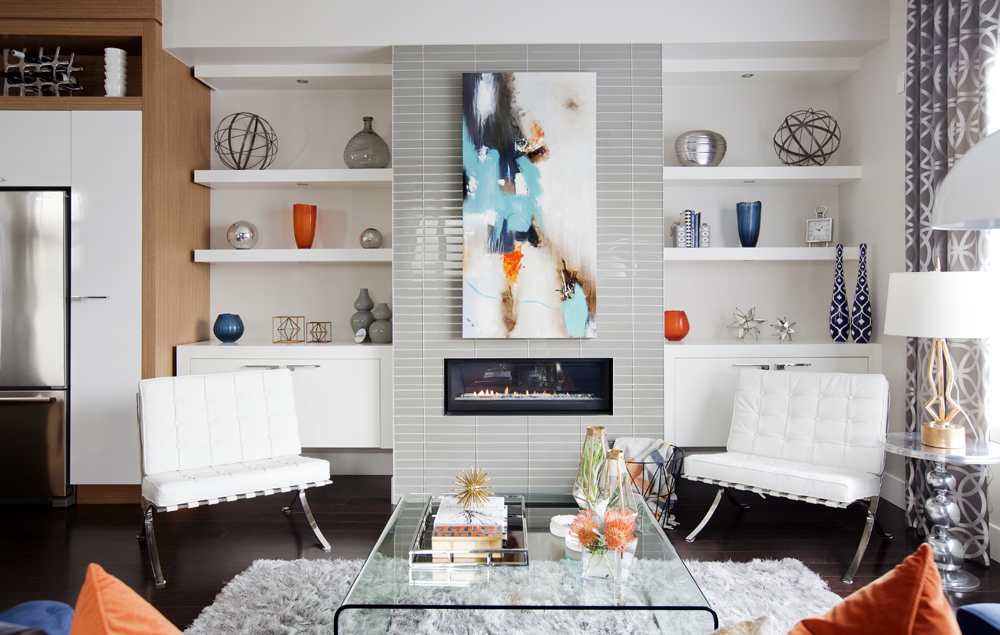 Modern living room with bold blue and orange accessories.