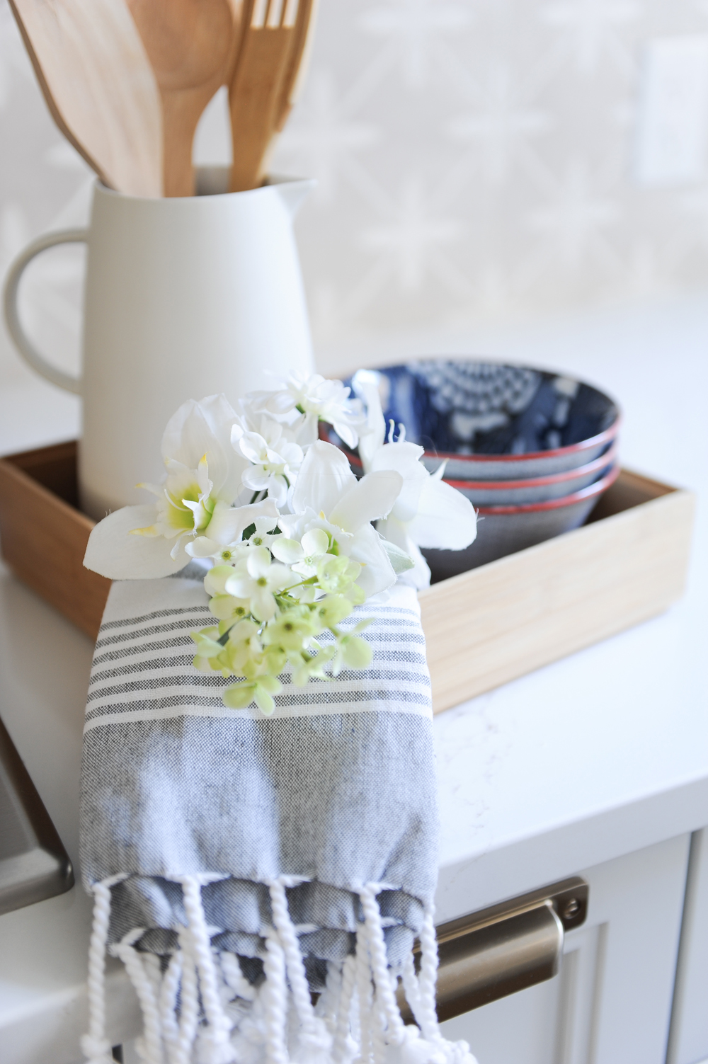 flowers, tea towel, three bowls and white jug