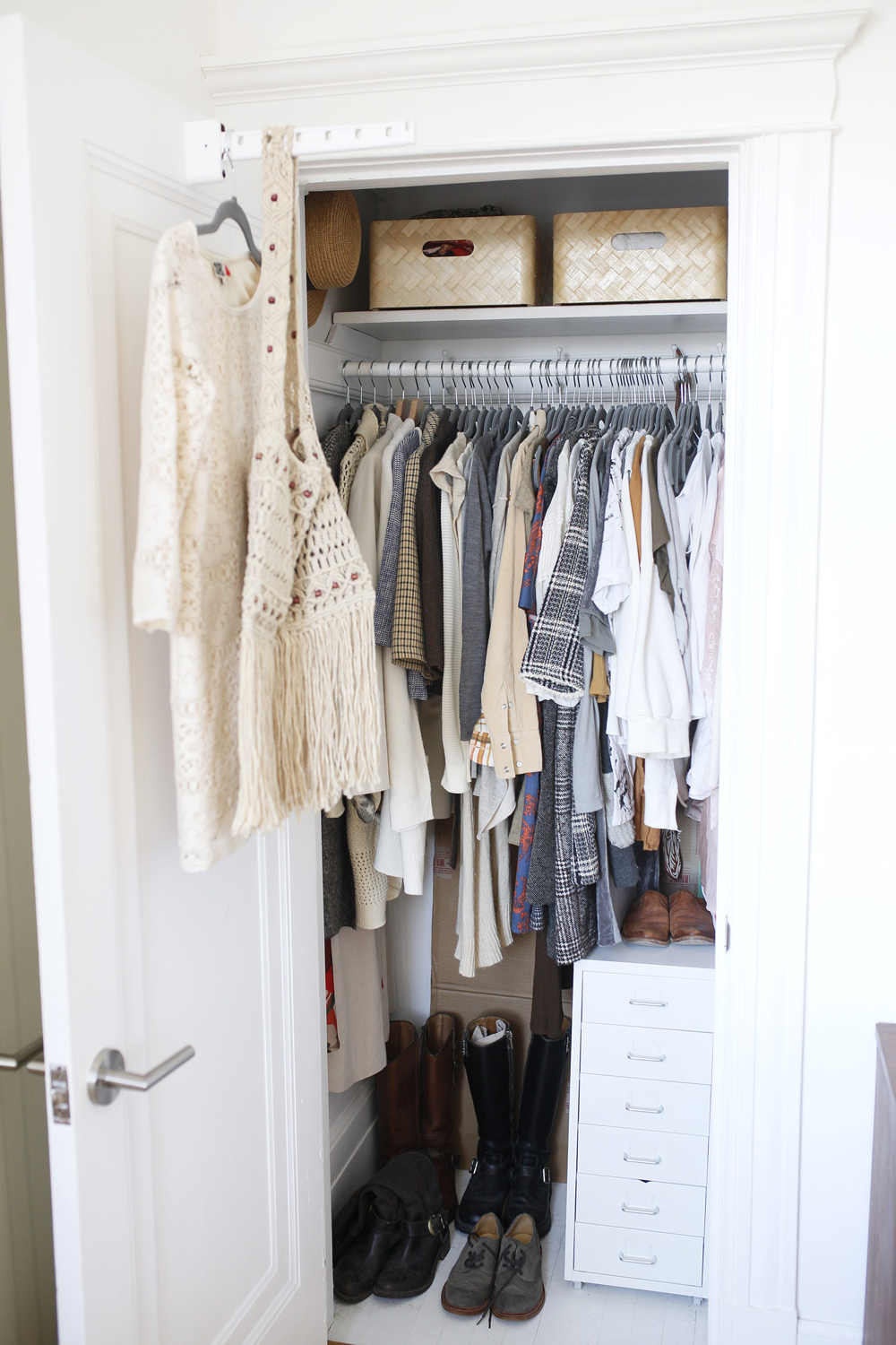 closet with white drawers and upper woven baskets