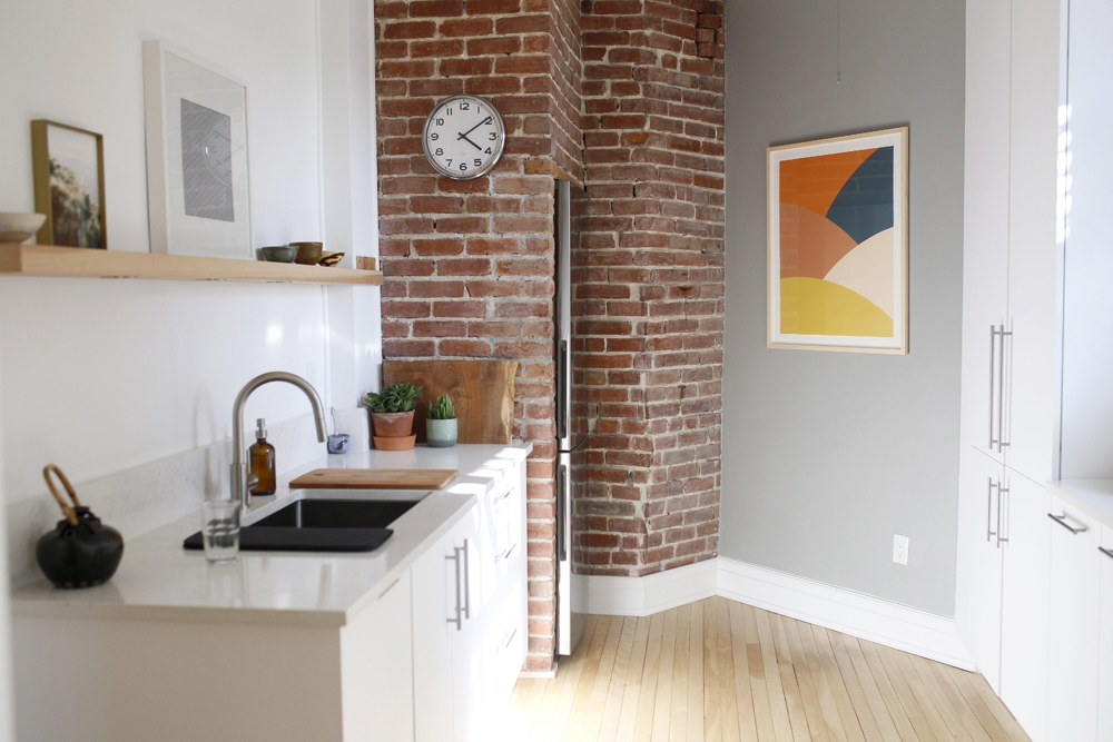 kitchen, brick wall, ten after four clock