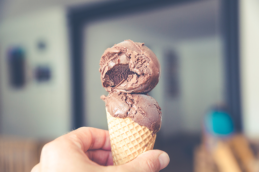 Hand holding a chocolate ice cream cone