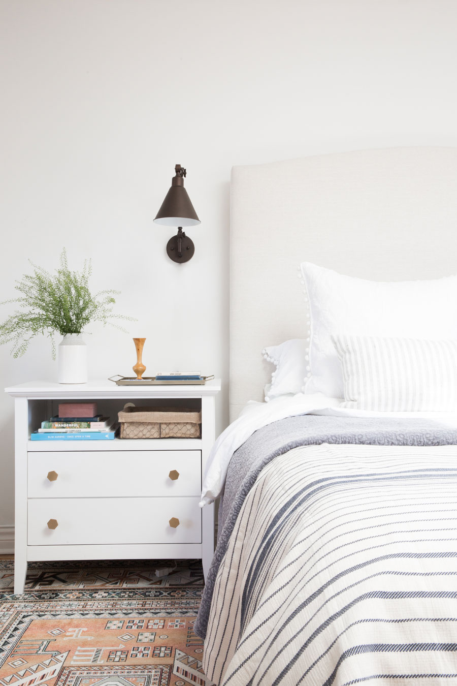 A coastal bedroom and a white night stand