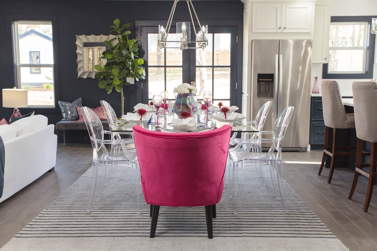 masters of flip dining room with acrylic chairs and lush pink armchairs