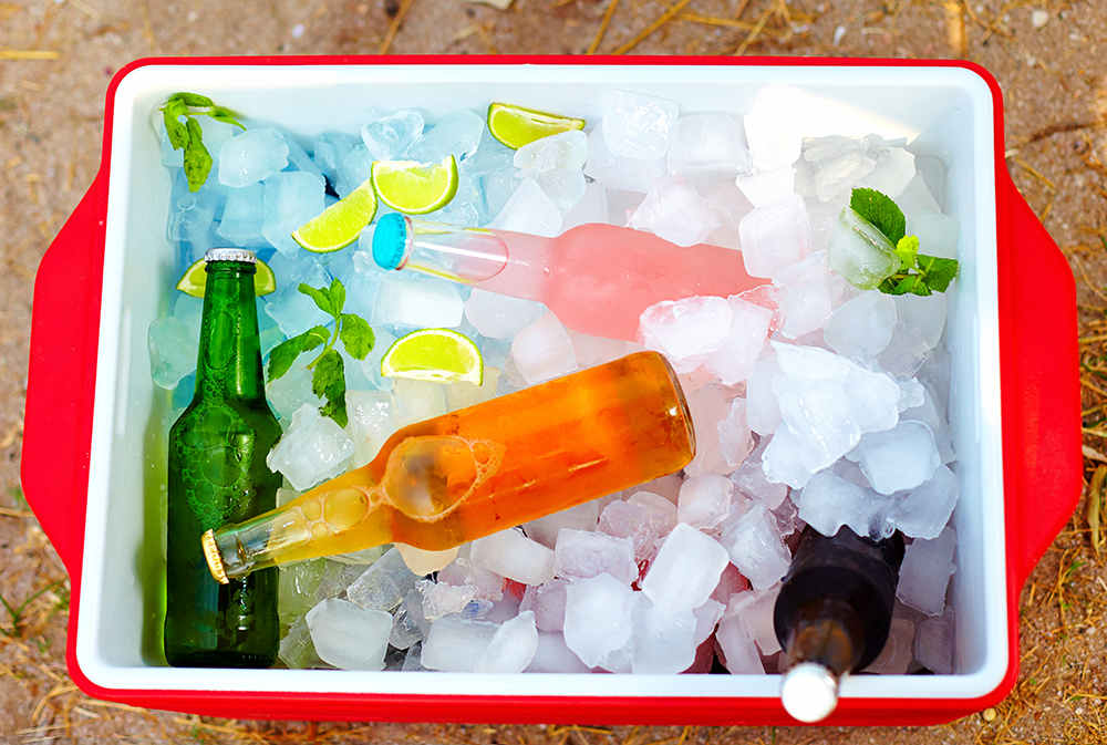 Chilled colorful beverages in ice box at a summer party