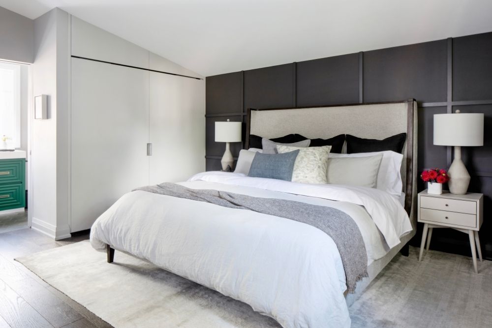A renovated master bedroom with a door leading into the ensuite bathroom