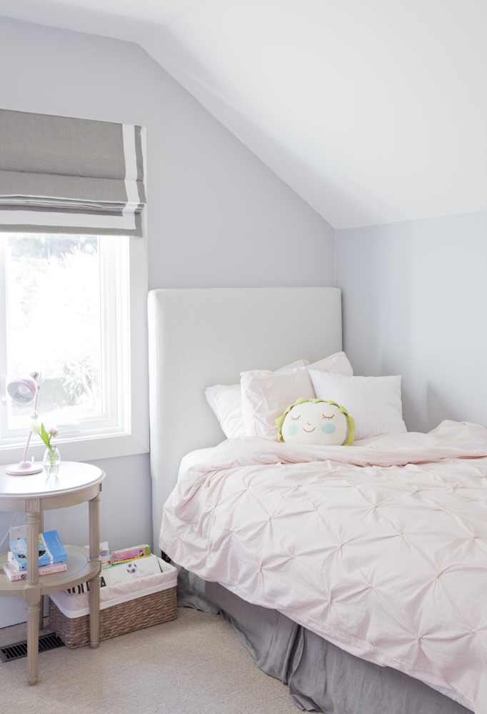 A pastel pink duvet cover in a bright, little girl's room