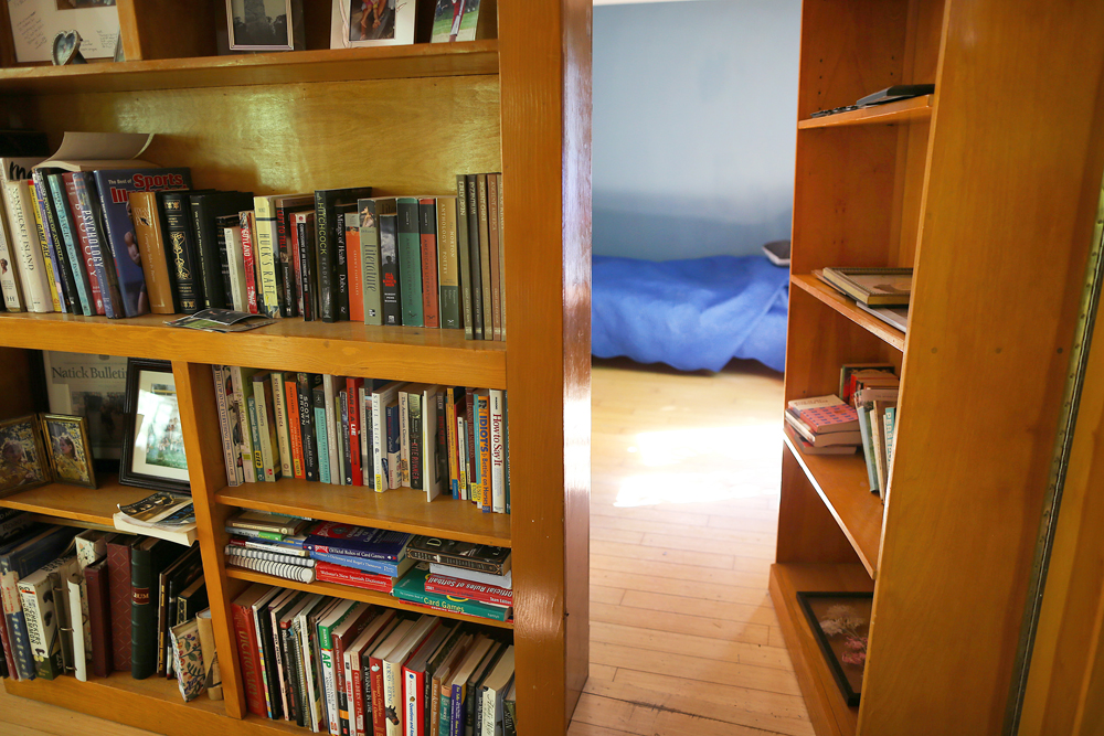 A heavy wooden bookshelf that opens into a secret bedroom