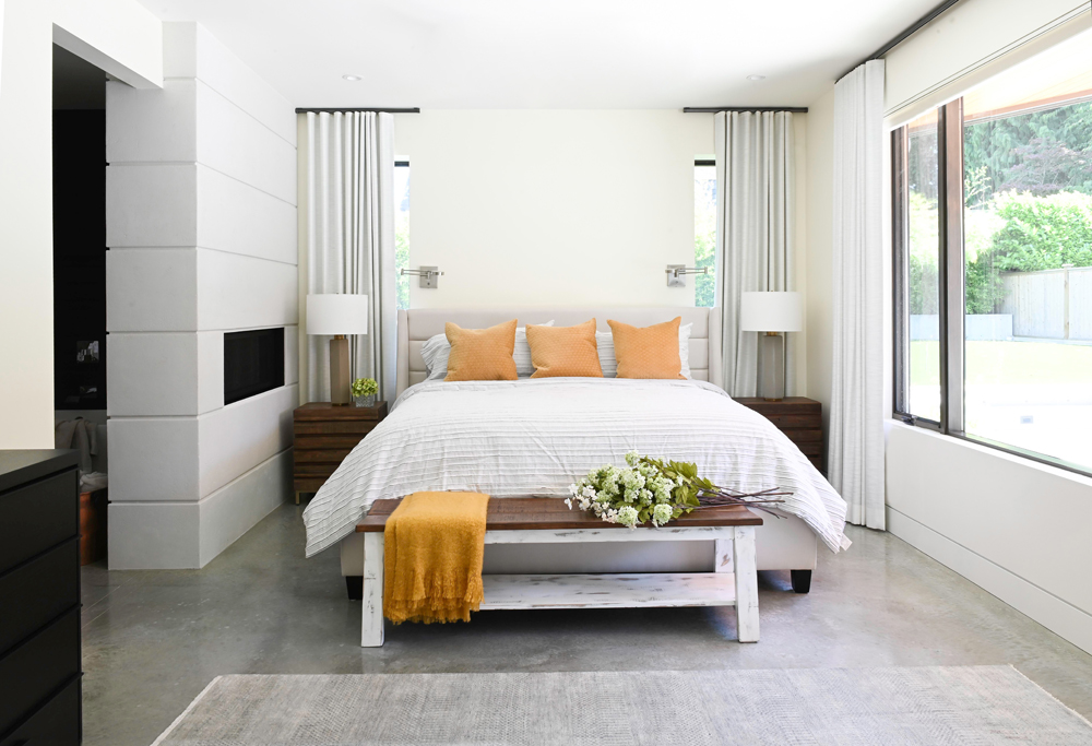 a modern bedroom with orange accents