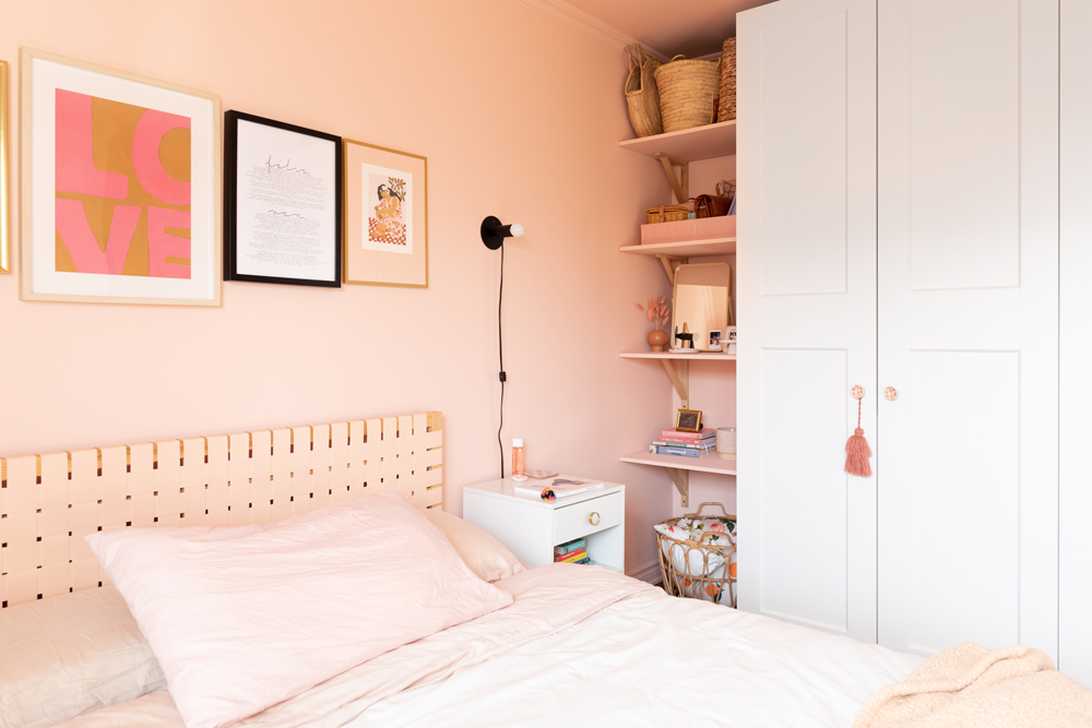 soft pink bedroom with hidden row of shelves beside cabinet
