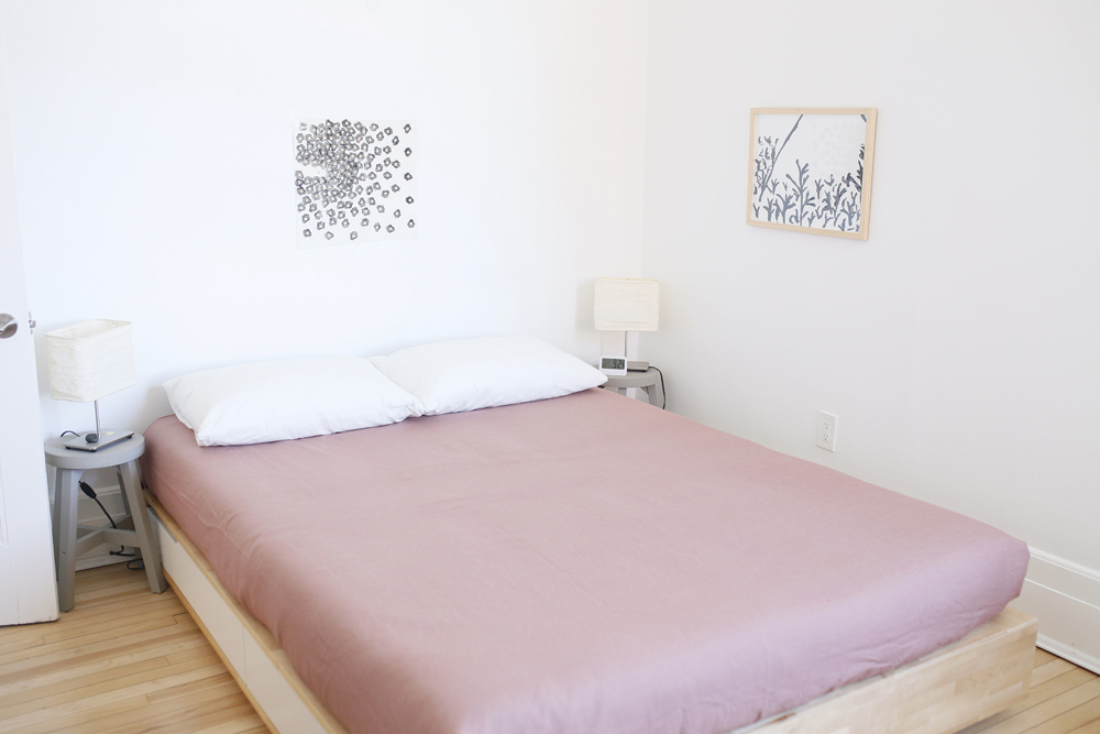 minimal white bedroom with pink bed
