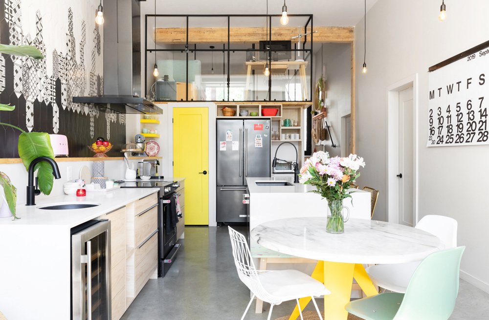 A bold and colourful eco-conscious kitchen in a Montreal home, complete with soaring ceilings and walk-in pantry