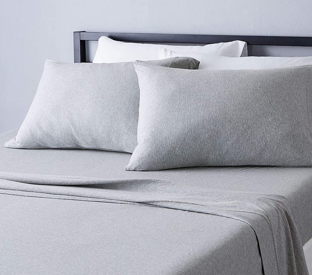 grey heathered sheets on bed with black bed frame