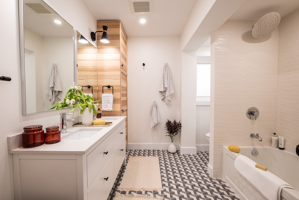 white bathroom with patterned tile and wood storage lockers