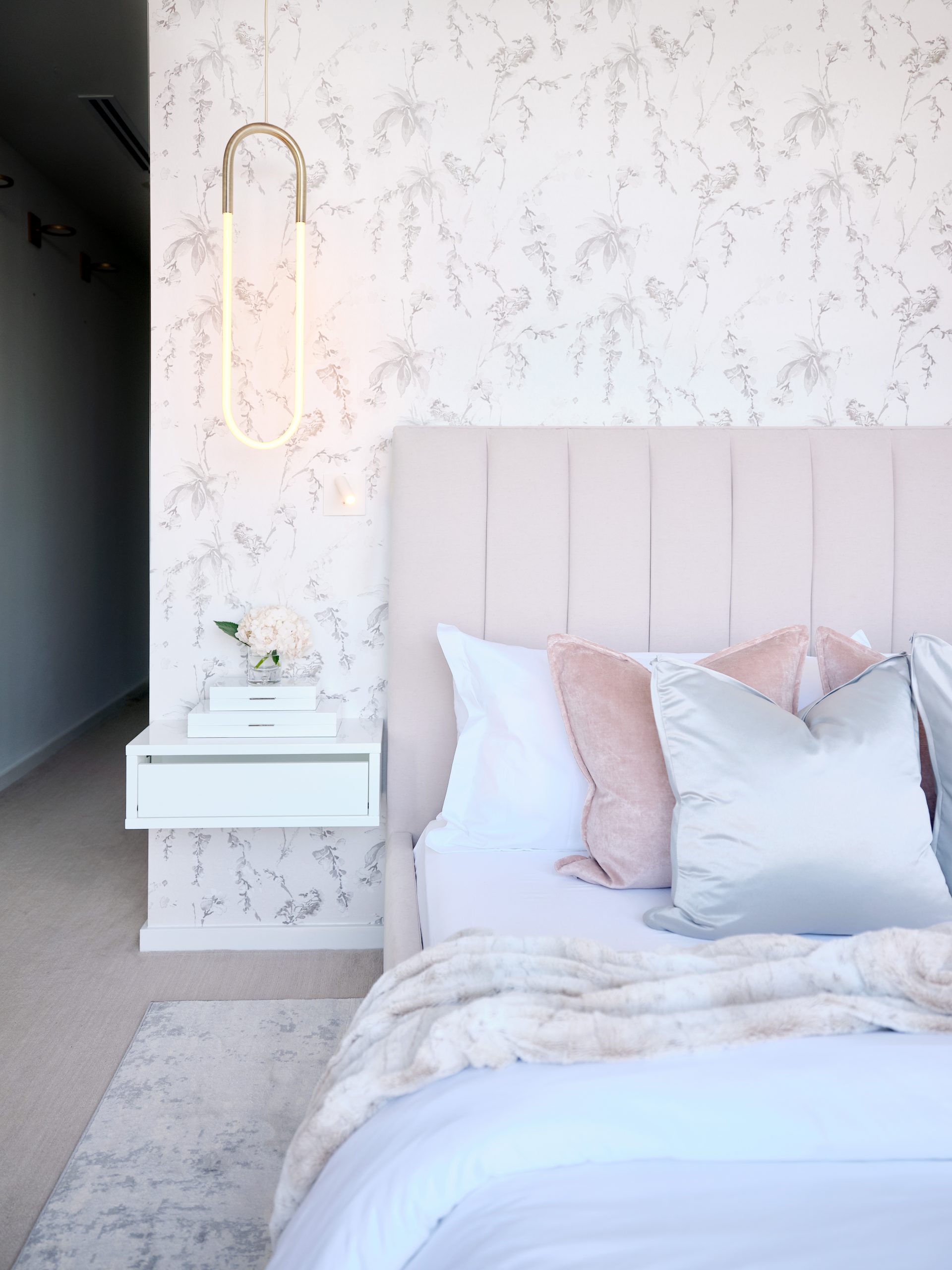 Pretty pink bedroom with pale floral pink wallpaper