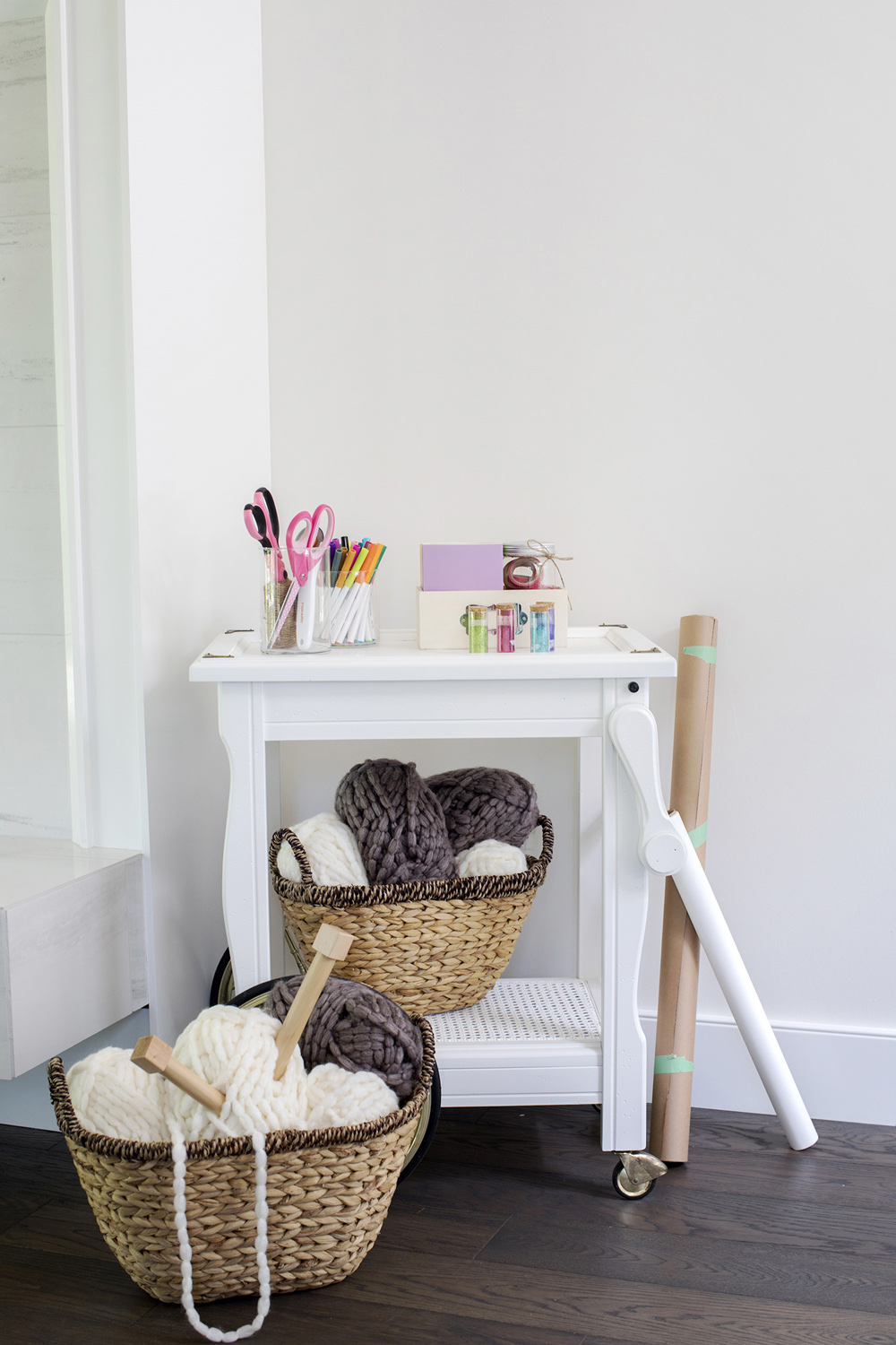 A corner with a basket of knitting needles and yarn