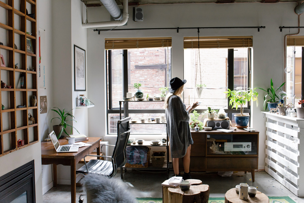 A woman standing in her home workspace