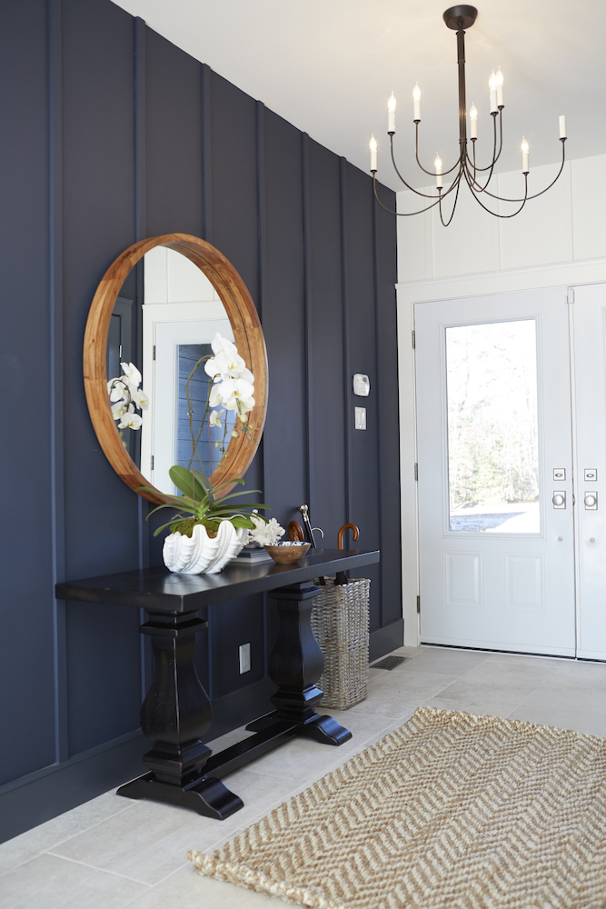 Inviting entryway with navy blue wall panelling.