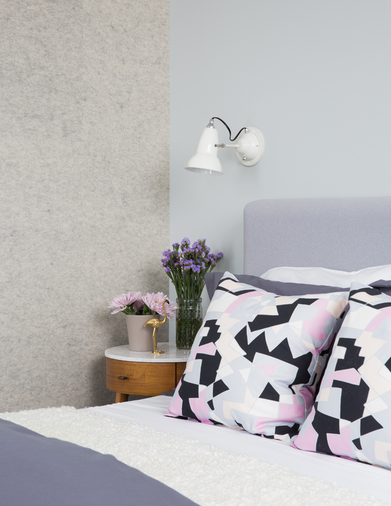 Bedroom with lavender headboard and blue and grey walls