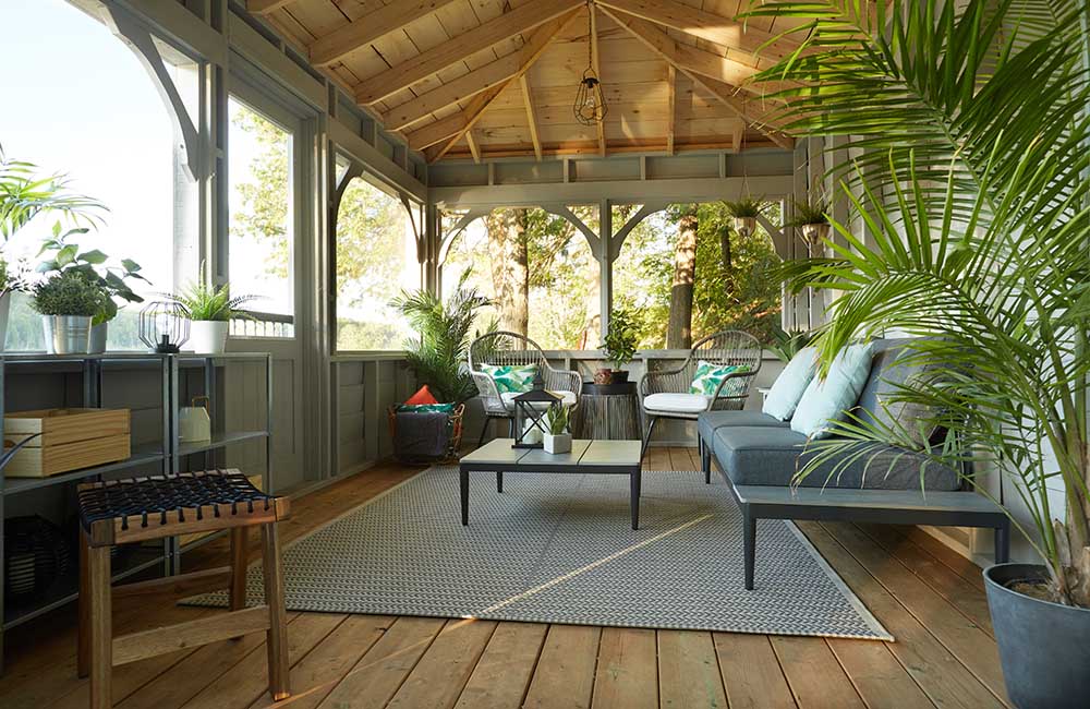 A lakeside sunroom where guests can enjoy the view and shelter from the bugs and rain