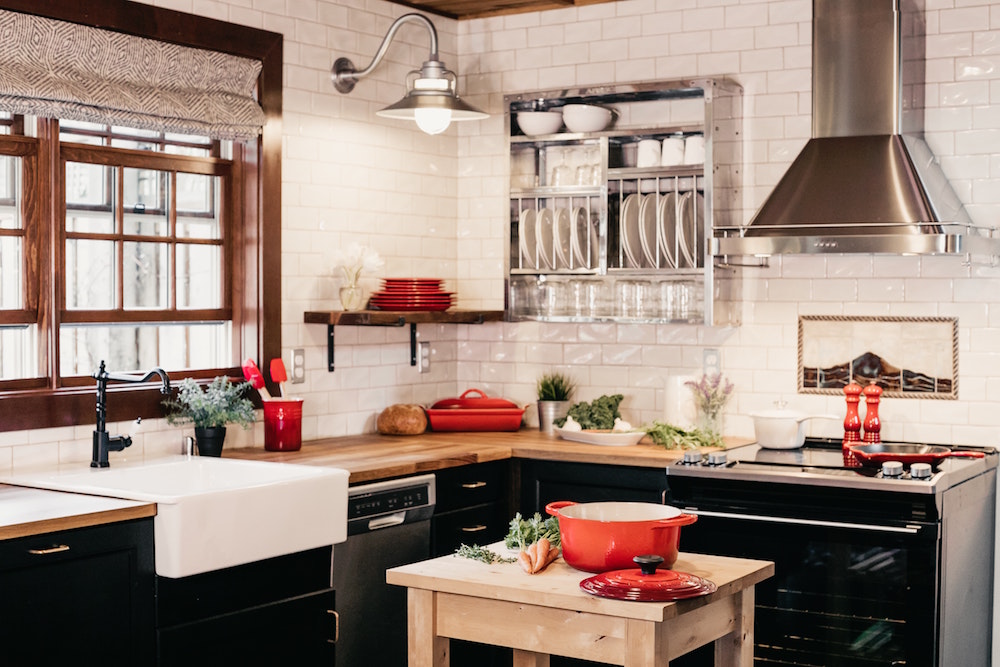 kitchen with black lower cabinets and red accents