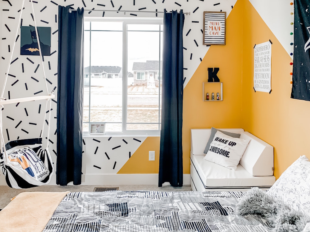 white, yellow and navy kids room with navy curtains